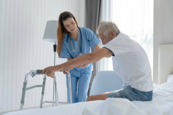 老年人在医院与医生和护士交谈 老年男性在接受治疗 护理和实习后 从专业医生那里散步 感到快乐 疗养院 — 图库照片