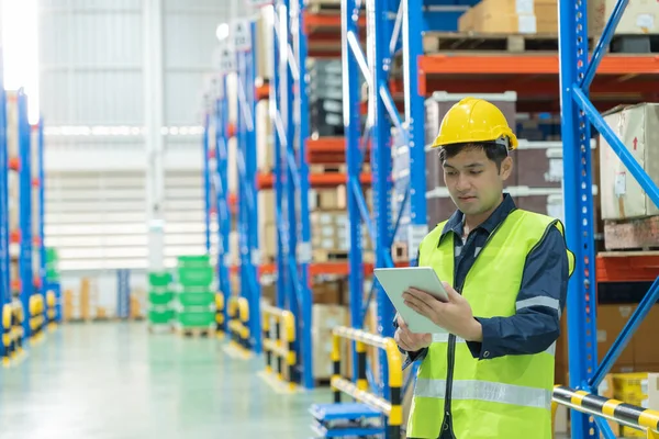 Asian male factory manager inspect goods in warehouse or inventory and check stock product. Transport logistic business shipping, delivery to customers. inspection, storehouse, storage, factory