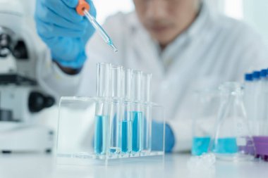 Scientist analyze biochemical samples in advanced scientific laboratory. Medical professional use dropper mix microbiological developmental of viral. Biotechnology research in  science lab. cosmetic