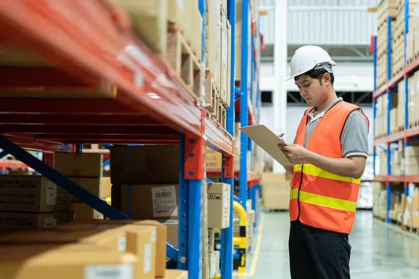 stock image Asian male factory manager inspect goods in warehouse or inventory and check stock product. Transport logistic business shipping, delivery to customers. inspection, storehouse, storage, factory