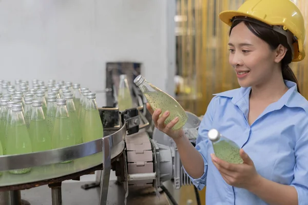 stock image quality supervisor food or beverages technician inspection about quality control food or beverages before send product to the customer. Production leader recheck ingredient and productivity.