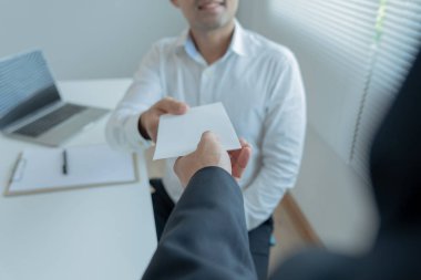 Businessmen receive salary or bonuses from management or Boss. Company give rewards to encourage work. Smiling businessman enjoying a reward at the desk in the office.