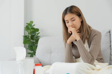 sick woman with a headache sitting under blanket, female sneezing and runny nose with seasonal influenza, allergic, high fever and influenza, resting, virus, coronavirus, feel illness, respiratory