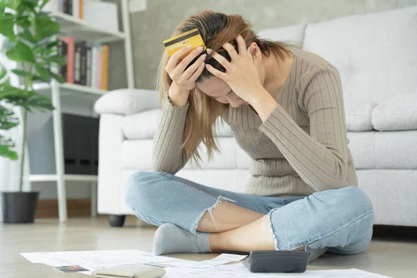 stock image Stressed and headache asian woman with large bills or invoices no money to pay to expenses and credit card debt. shortage, Financial problems, mortgage, loan, bankruptcy, bankrupt, poor, empty wallet