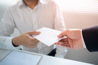 Businessmen receive salary or bonuses from management or Boss. Company give rewards to encourage work. Smiling businessman enjoying a reward at the desk in the office.