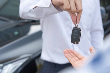 lease, rental car, sell, buy. Dealership manager send car keys to the new owner.  Sales, loan credit financial, rent vehicle, insurance,  renting, Seller, dealer, installment, car care busines
