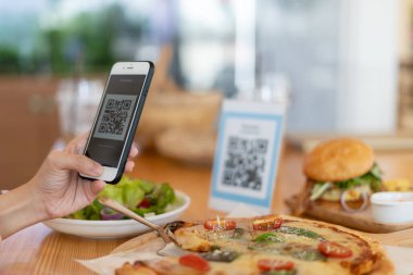 Woman use smartphone to scan QR code to pay in cafe restaurant with a digital payment without cash. Choose menu and order accumulate discount. E wallet, technology, pay online, credit card, bank app. clipart