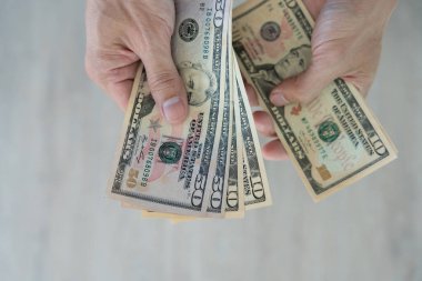 USD currency , Many dollar bank notes Placed on the table.The  Dollar is the currency of USA that is used to change, buy, sell, accumulate, and invest in united kingdom's state people.