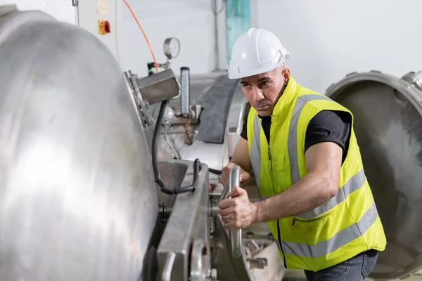 stock image Engineers or factory managers wearing safety helmet inspect the machines in the production line. Utility inspector check machine and test the system to meet the standard. machine, maintenance.