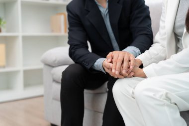 Couple hold hand support each while discussing family issues with psychiatrist. Husband encourages and empathy wife suffers depression. psychological, save divorce, Hand in hand together, trust, care