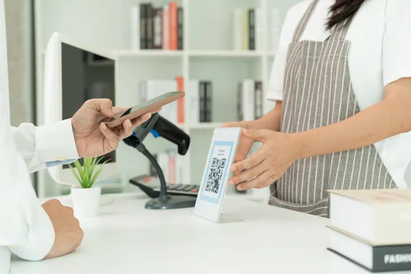 Customer use smartphones to scan QR codes to pay in-store with digital payments without cash. scanning get discounts. E wallet, technology, online payment, banking app, smart city, money transfer.