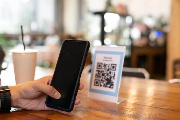 man use smartphone to scan QR code for order menu in cafe restaurant with a digital delivery. Choose menu and order accumulate discount. E wallet, technology, pay online, credit card, bank app.