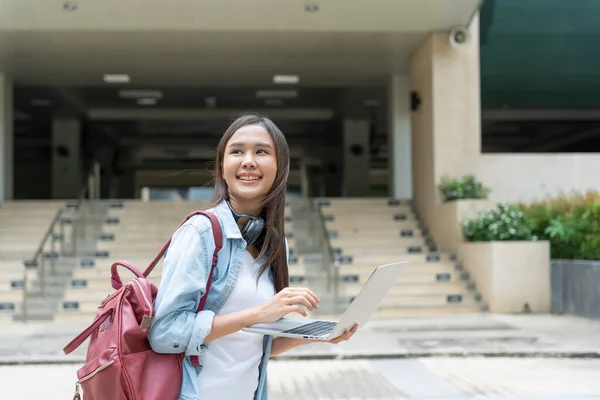 stock image Beautiful student asian woman with backpack and books outdoor. Smile girl happy carrying a lot of book in college campus. Portrait female on international Asia University. Education, study, school