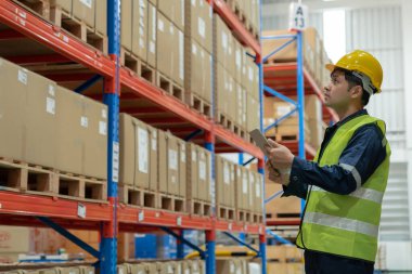 Asian male factory manager inspect goods in warehouse or inventory and check stock product. Transport logistic business shipping, delivery to customers. inspection, storehouse, storage, factory