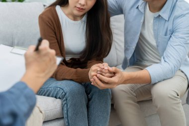 Couple hold hand support each while discussing family issues with psychiatrist. Husband encourages and empathy wife suffers depression. psychological, save divorce, Hand in hand together, trust, care