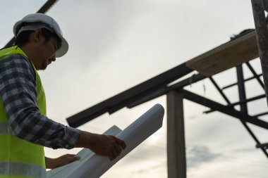 Müfettiş ya da mühendis mavi baskı kullanarak inşaat ve kalite güvencesini denetliyor. Mühendis, mimar ya da irtibat kurucu ev sahibine teslim etmeden önce evi inşa etmek için çalışır.