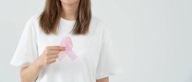Woman hold pink ribbon breast cancer awareness. Female health check consciousness. international Women Day and World Cancer Day. sign cancer, Symbolic, health care, support patients, timely diagnosis
