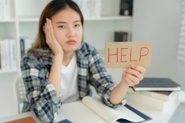 Asian student woman have anxiety because of exams, female prepare for test and learning lessons in the library. stress, despair, haste, misunderstanding reading, discouraged, expectation, knowledge