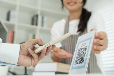 Customer use smartphones to scan QR codes to pay in-store with digital payments without cash. scanning get discounts. E wallet, technology, online payment, banking app, smart city, money transfer.