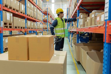Warehouse worker pick box goods in inventory and check stock product. Transport logistic business ship delivery to customer. stock card, bill of material, inspection, storehouse, storage, factory