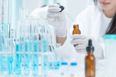 Scientist analyze biochemical samples in advanced scientific laboratory. Medical professional use dropper mix microbiological developmental of viral. Biotechnology research in  science lab. cosmetic