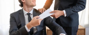 Businessmen receive salary or bonuses from management or Boss. Company give rewards to encourage work. Smiling businessman enjoying a reward at the desk in the office.