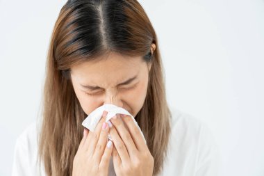 Polen alerjisi, mendile hapşıran Asyalı genç bir kadın veya mendile üfleyerek bahar çiçeklerine ya da bahar çiçeklerine alerjisi olan bir kadın. alerjik reaksiyon, solunum sistemi sorunları
