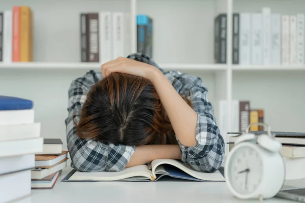 Asian student woman have anxiety because of exams, female prepare for test and learning lessons in the library. stress, despair, haste, misunderstanding reading, discouraged, expectation, knowledge