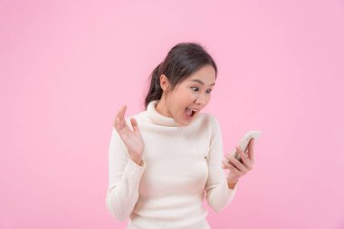 Asian beautiful woman exited surprise face expression . female feels shocked with the phone. exciting smile and happy adorable rejoices. Very enjoy and fun relax time. wow, girl holding smartphone.