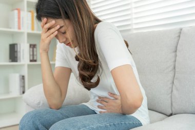stomach ache. Asian women have abdominal pain, indigestion, gastritis, menstrual cramps, flatulence, diarrhea, distention, colon cancer, belly inflammation problem, suffer food poisoning, abdomen