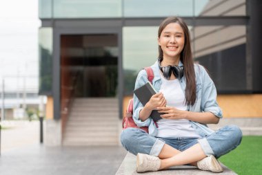 Beautiful student asian woman with backpack and books outdoor. Smile girl happy carrying a lot of book in college campus. Portrait female on international Asia University. Education, study, schoo