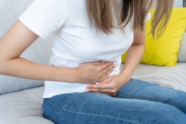 stomach ache. Asian women have abdominal pain, indigestion, gastritis, menstrual cramps, flatulence, diarrhea, distention, colon cancer, belly inflammation problem, suffer food poisoning, abdome