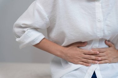 stomach ache. Asian women have abdominal pain, indigestion, gastritis, menstrual cramps, flatulence, diarrhea, distention, colon cancer, belly inflammation problem, suffer food poisoning, abdomen
