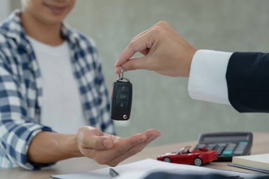 lease, rental car, sell, buy. Dealership manager send car keys to the new owner.  Sales, loan credit financial, rent vehicle, insurance,  renting, Seller, dealer, installment, car care busines