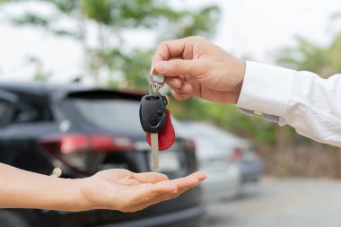 lease, rental car, sell, buy. Dealership manager send car keys to the new owner.  Sales, loan credit financial, rent vehicle, insurance,  renting, Seller, dealer, installment, car care busines