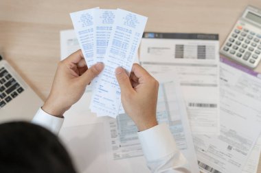 Stressed and headache man with large bills or invoices no money to pay to expenses and credit card debt. shortage, Financial problem, bankruptcy, mortgage, loan, bankrupt, poor, empty wallet 