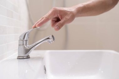 Save water. Volunteer keeps turning off the running water in the bathroom to protect environment. Greening planet, reduce global warming, Save world, life, future, risk energy, crisis , water day