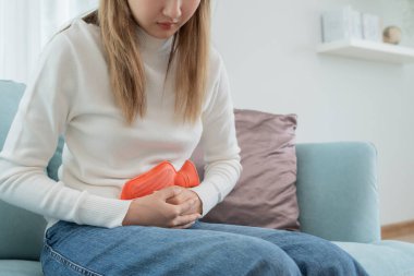 stomach ache. Asian women have abdominal pain, indigestion, gastritis, menstrual cramps, flatulence, diarrhea, distention, colon cancer, belly inflammation problem, suffer food poisoning, abdome