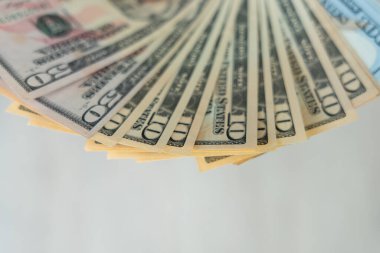 USD currency , Many dollar bank notes Placed on the table.The  Dollar is the currency of USA that is used to change, buy, sell, accumulate, and invest in united kingdom's state people