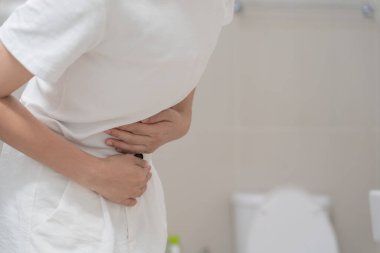 Constipation and diarrhea in bathroom. Hurt woman touch belly  stomach ache painful. colon inflammation problem, toxic food, abdominal pain, abdomen, constipated in toilet, stomachache, Hygiene