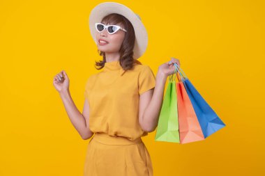 Modern happy asian Female lifestyle fashion portrait. beautiful attractive young woman girl enjoy stylish walk with shopping bag packages on the street, trendy outfit on shopping mall, browse product