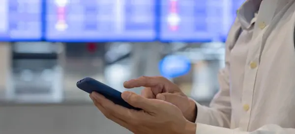 Επιχειρηματίας Που Χρησιμοποιεί Κινητό Τηλέφωνο Για Κλείσετε Αεροπορικό Εισιτήριο Μέσω — Φωτογραφία Αρχείου