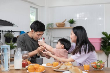 daughter is kissing her father's cheek. activities together during the holidays. Parents and children are having activity on vacant time. weekend, enjoyment, happy family, togetherness, feel good
