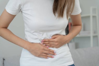 stomach ache. Asian women have abdominal pain, indigestion, gastritis, menstrual cramps, flatulence, diarrhea, distention, colon cancer, belly inflammation problem, suffer food poisoning, abdomen