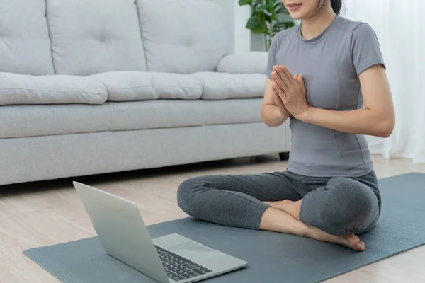 stock image Slim woman practicing yoga on room of her condo or home. Asian woman doing exercises in morning. balance, meditation, relaxation, calm, good health, happy, relax, healthy lifestyle, diet, sli