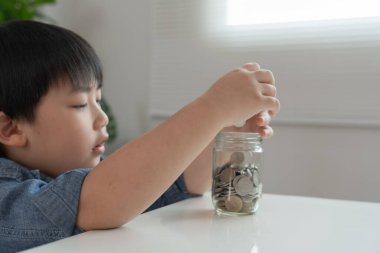 Save money. children putting coin for saving. wealth, Finance, insurance, investment, education, future, plan life, learn, banking, family, health, health and accident insurance.