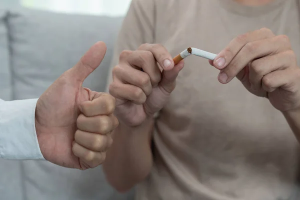 stock image No smoking. Man stop smoke, refuse, reject, break take cigarette, say no. quit smoking for health. world tobacco day. drugs, Lung Cancer, emphysema , Pulmonary disease, narcotic, nicotine effect