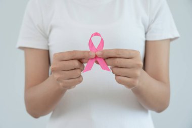 Woman hold pink ribbon breast cancer awareness. Female health check consciousness. international Women Day and World Cancer Day. sign cancer, Symbolic, health care, support patients, timely diagnosis