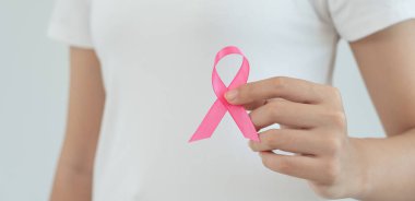 Woman hold pink ribbon breast cancer awareness. Female health check consciousness. international Women Day and World Cancer Day. sign cancer, Symbolic, health care, support patients, timely diagnosis
