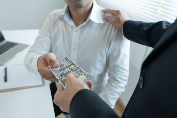 Businessmen receive salary or bonuses from management or Boss. Company give rewards to encourage work. Smiling businessman enjoying a reward at the desk in the office.